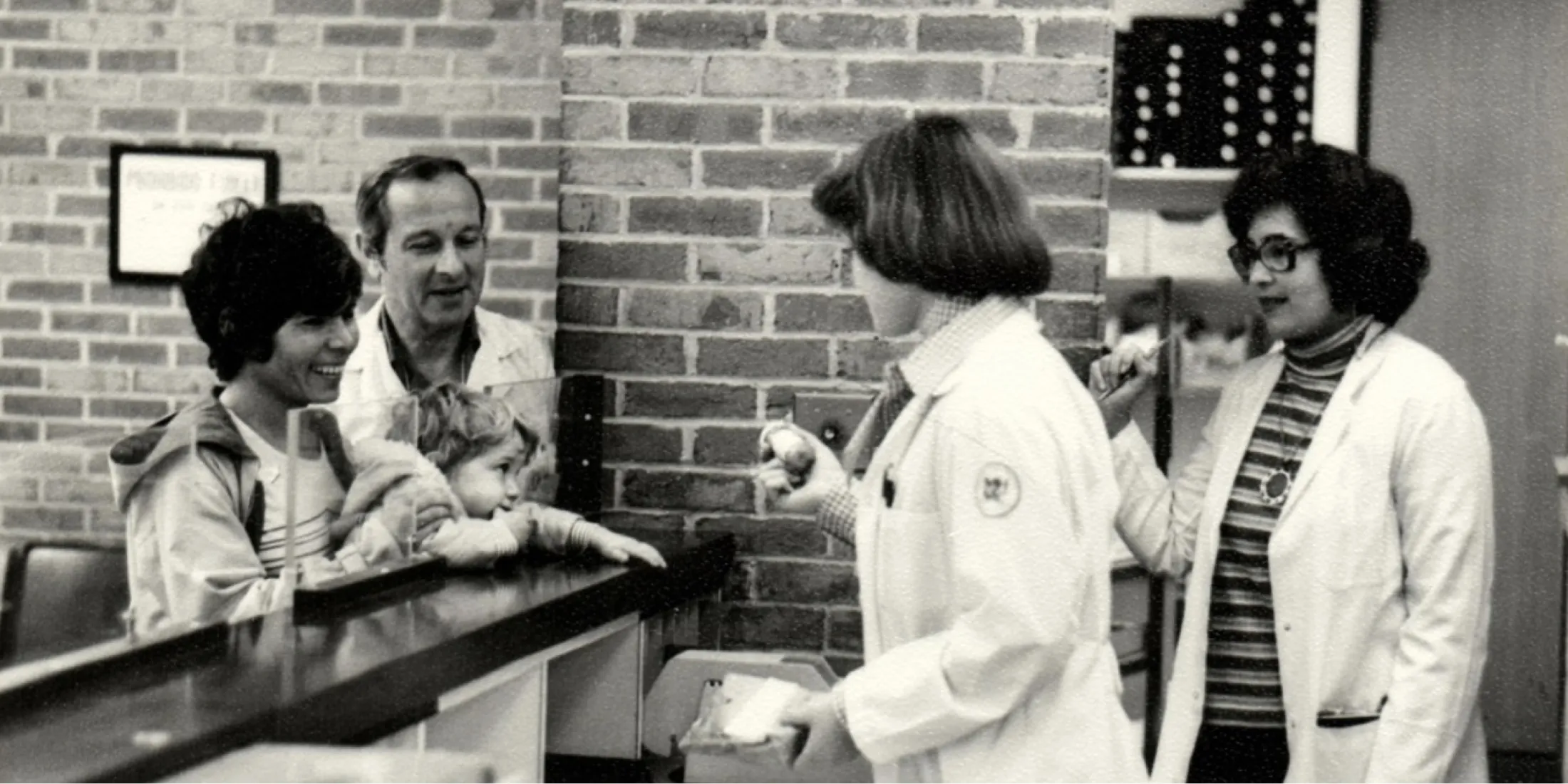 Pharmacists tending to customers at the counter