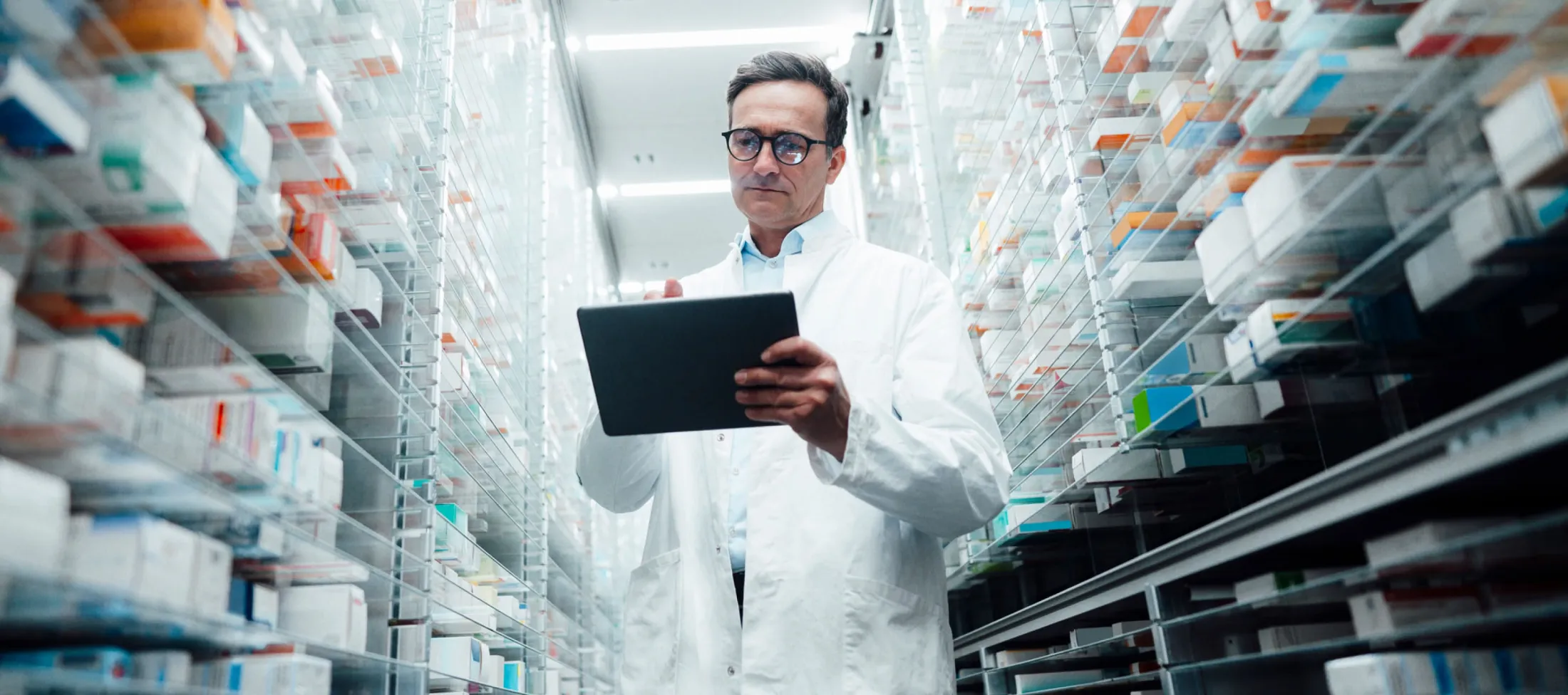 Pharmacist checking medicine inventory