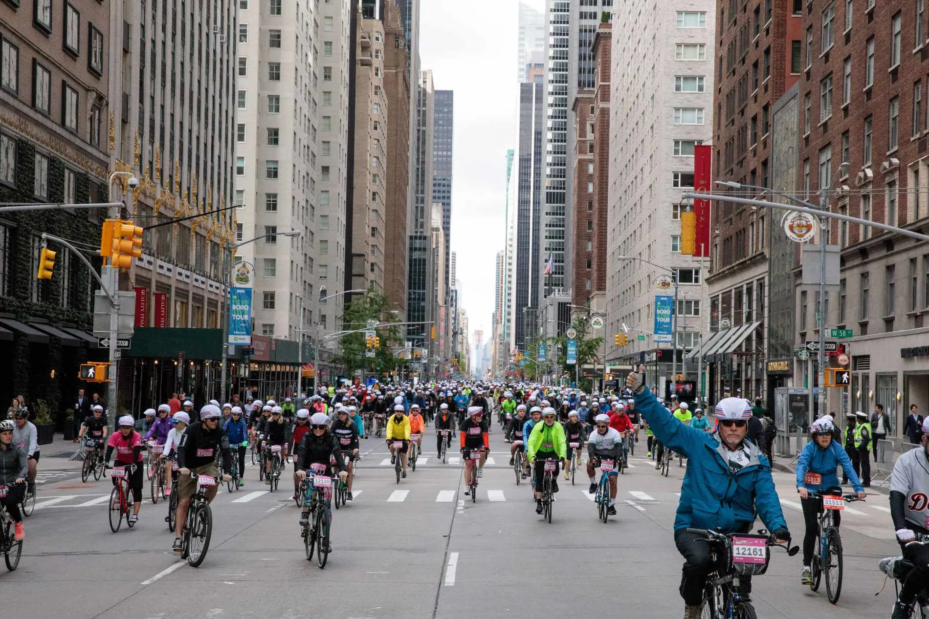 People racing through a city on bicycles