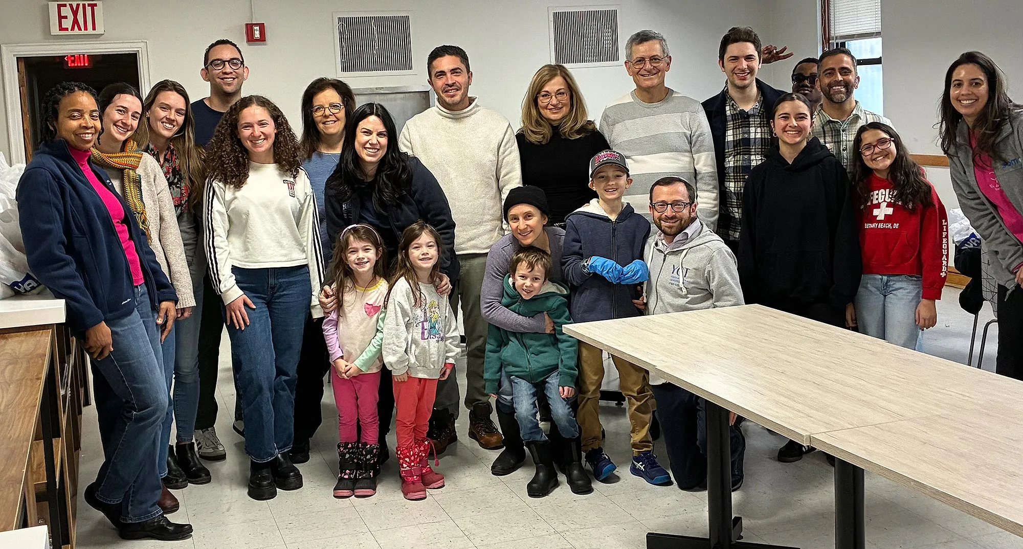 Dean Yaron Tomer, M.D., in gray striped sweater, with other volunteers at Niño de la Caridad during Einstein’s MLK Week of Service