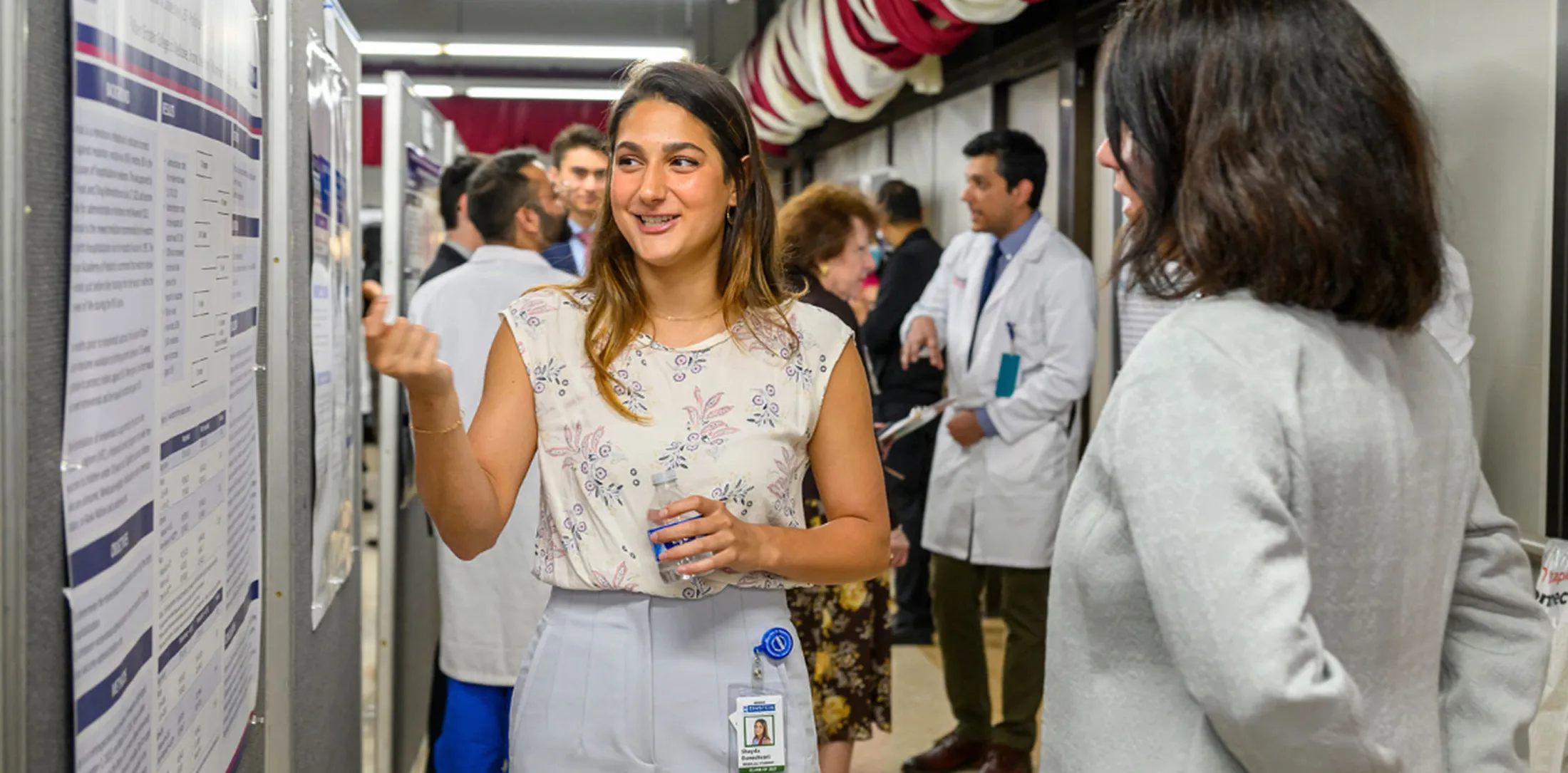 Medical professionals standing and talking in a hallway