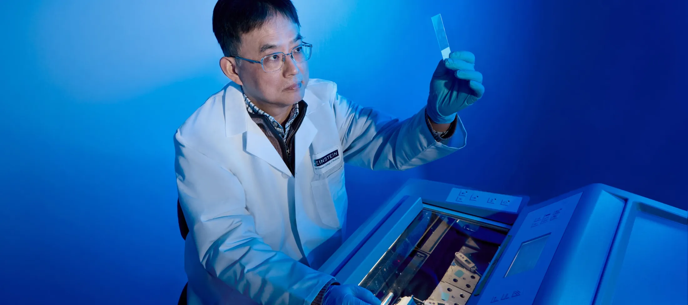 Scientists looking at a microscope slide