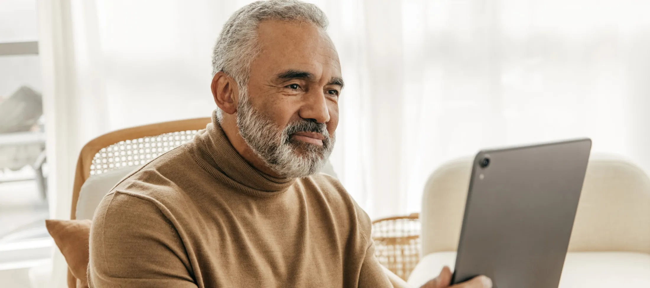 Man with beard looking at a tablet