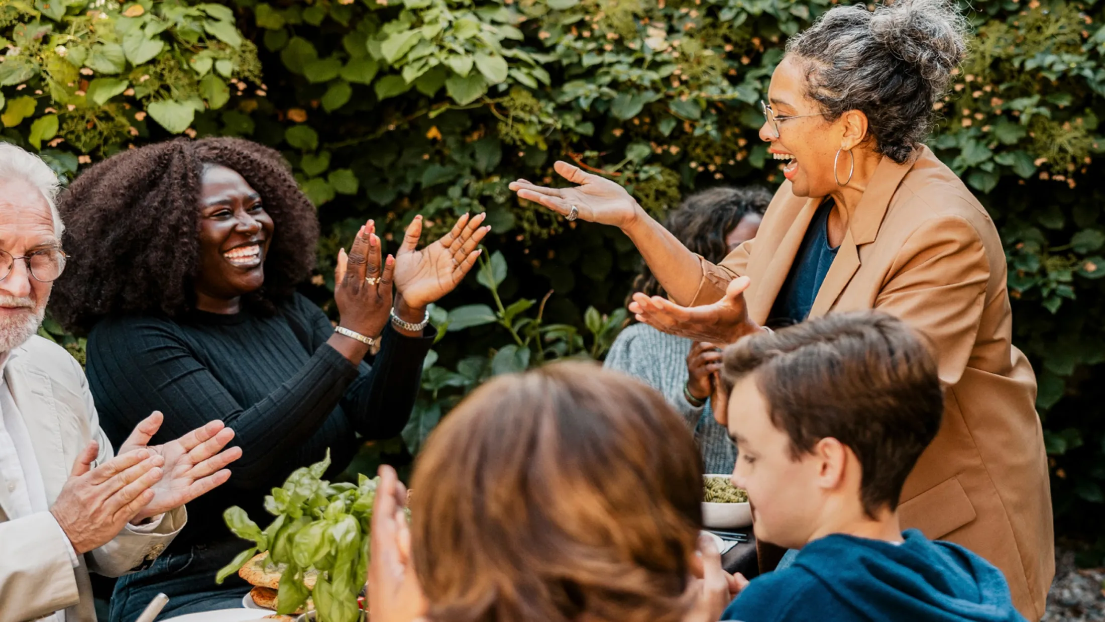 People enjoying a party at a garden clapping