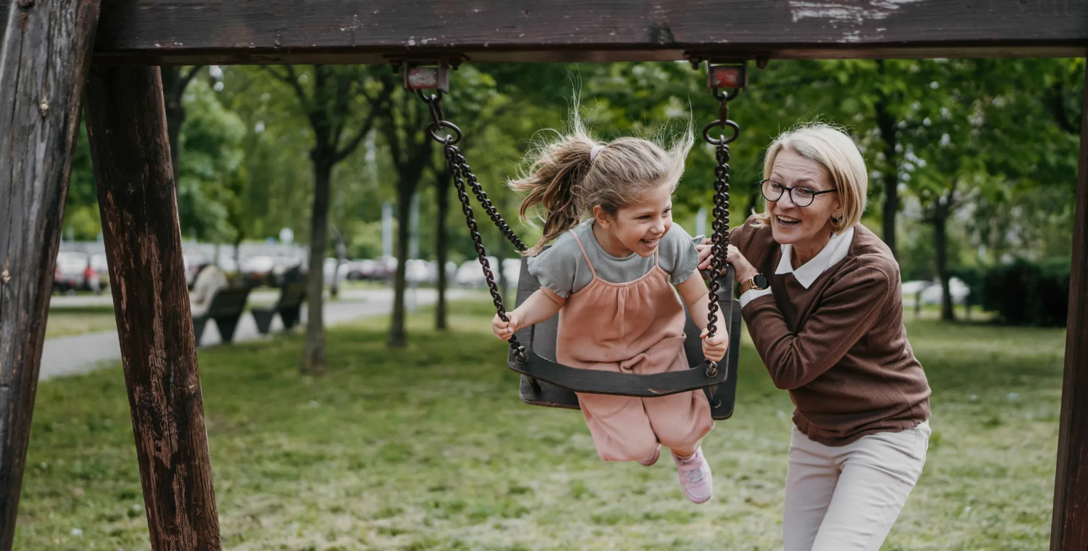 Woman playing with a child on a swing