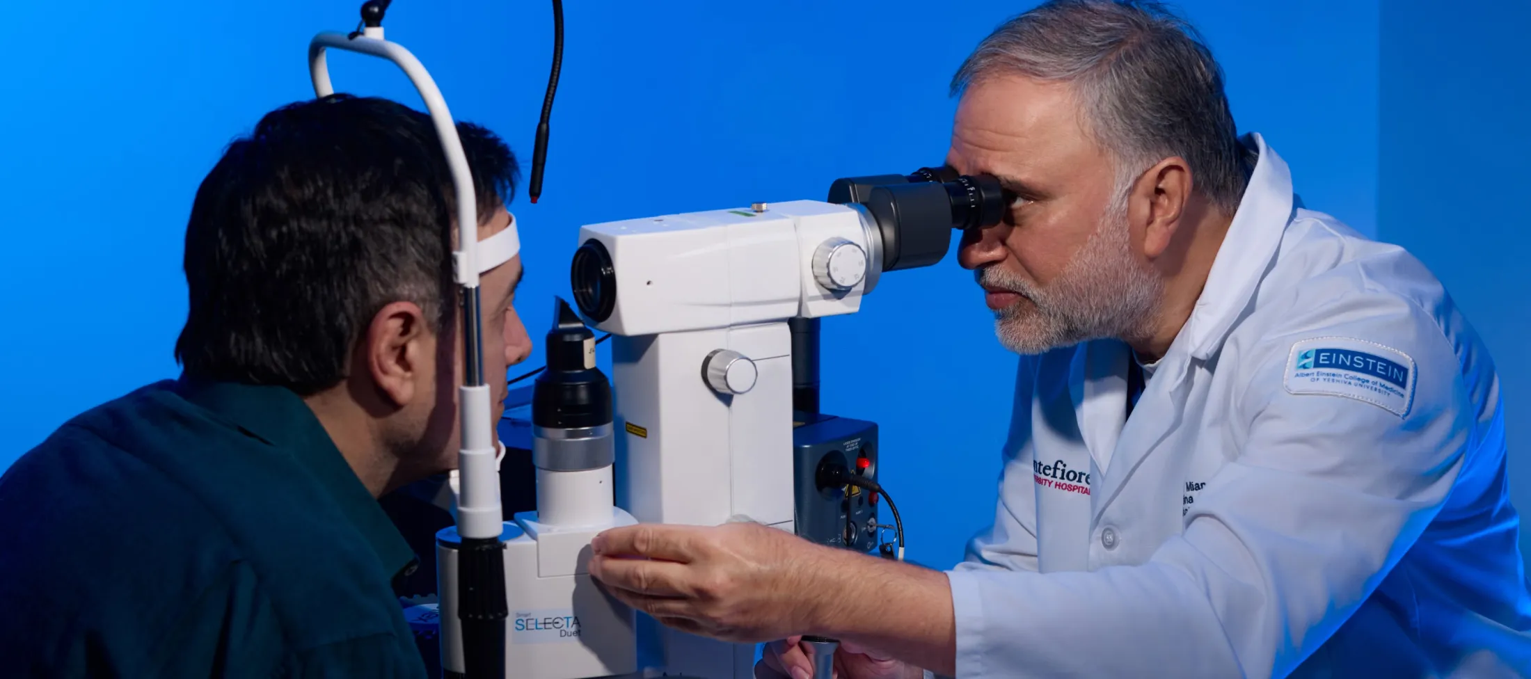An ophthalmologist examines a patient's eyes