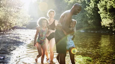 Family playing in a lake