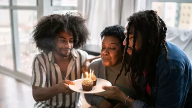 A family celebrating mother's birthday at home.