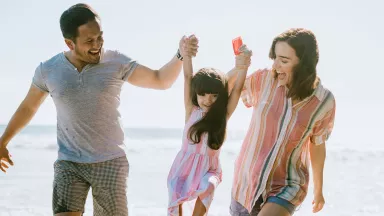 Loving family enjoying sun at the beach