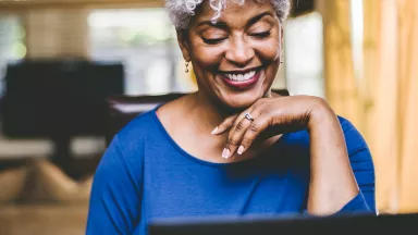 Cheerful woman on video call at home