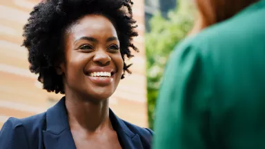 Female prospective business supplier smiling in conversation