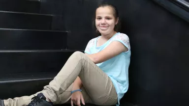 A young girl sitting on steps
