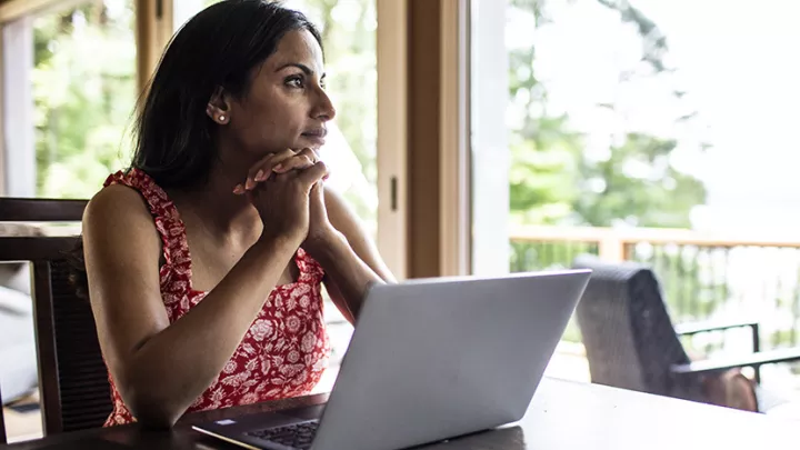  A woman sitting with a laptop.