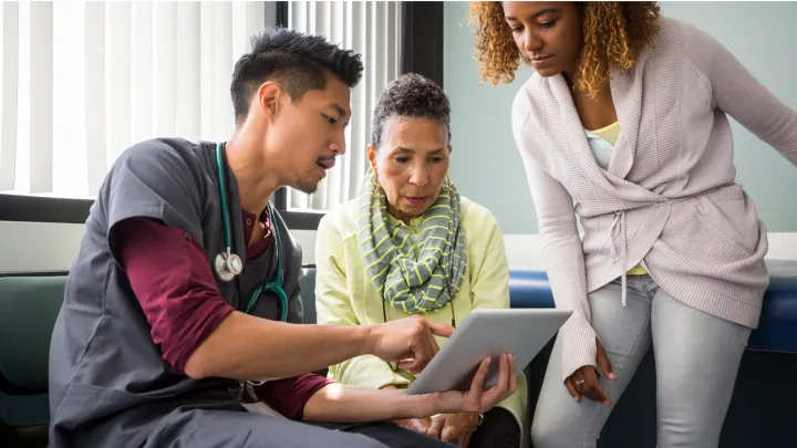 Doctor speaking with two patients about results