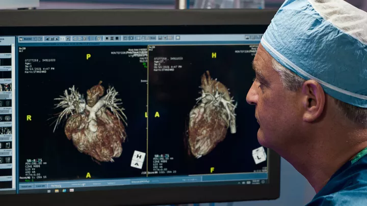 A surgeon in the OR looking at a computer screen