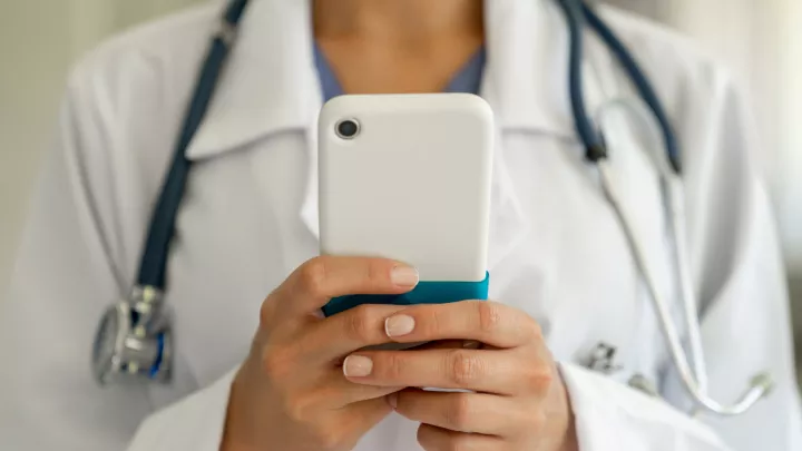 A physician talking with a patient at a stroke awareness event