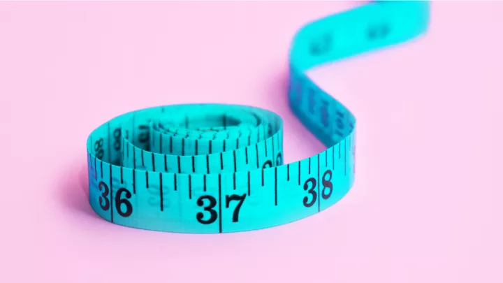 A taylor's tape measure partially uncoiled