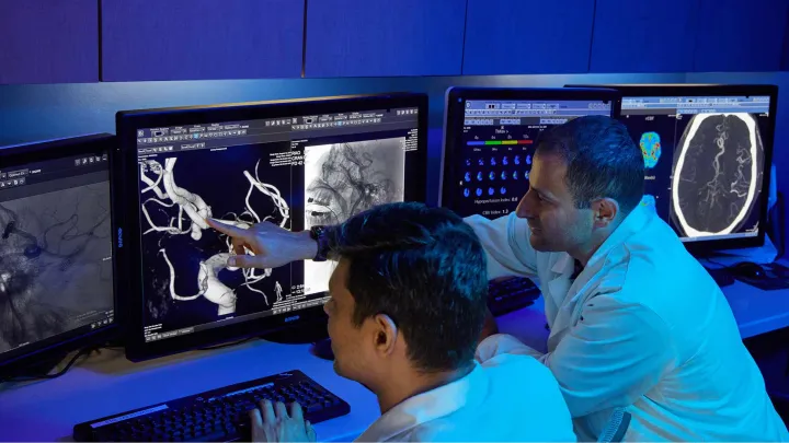 Doctors looking at computer screens