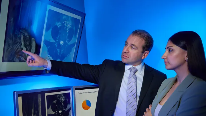 Medical researchers reviewing MRI scans and patient demographic charts.