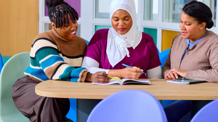 Team of three women sitting at at table