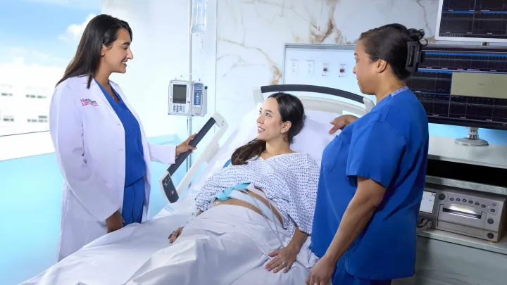 Doctor and Nurse speaking to a patient that is lying in bed
