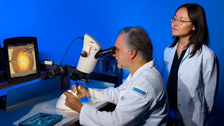 Dr examing eye through laser technology