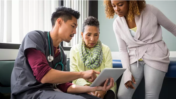 Doctor speaking with two patients about results