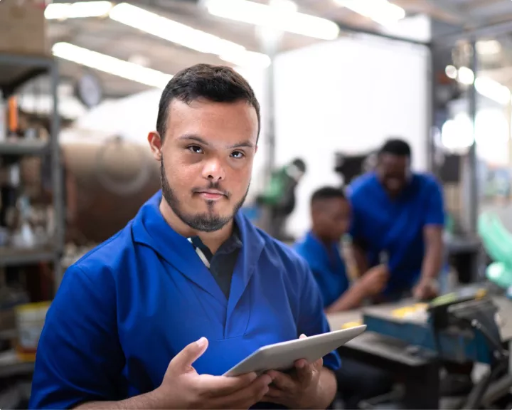 Young man holding tablet in warehouse