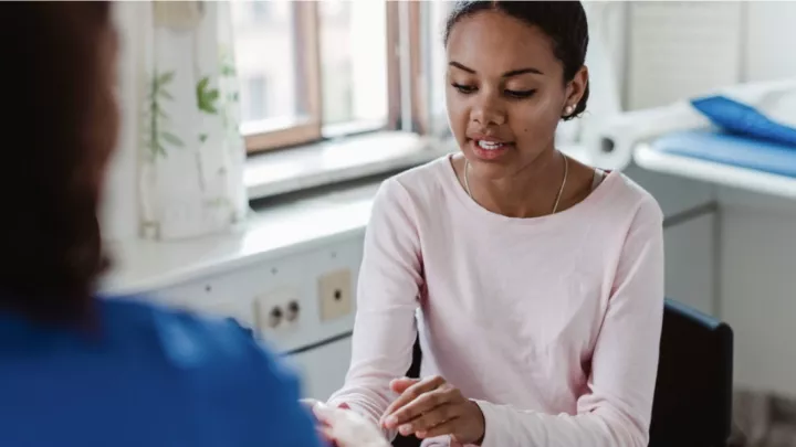 Woman in conversation with another person