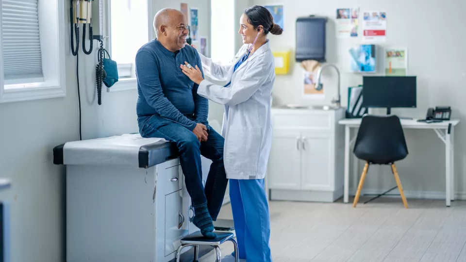Doctor Examining Patient in Blue Shirt