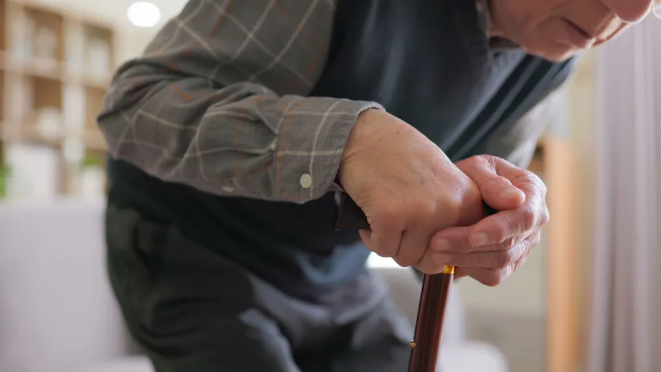 Elderly man having difficulty moving at home