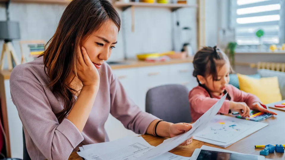Stressed mother going through her finances