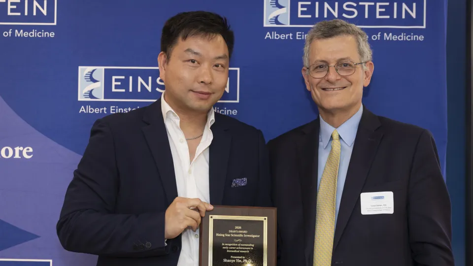 Shanye Yin, PhD, received the inaugural Dean’s Rising Star Scientific Investigator Award from Einstein Dean Yaron Tomer, MD, at the Spring Faculty Celebration held on June 3, 2026. in Lubin Dining Hall. 