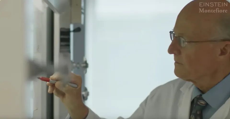 Medical professional writing on a whiteboard