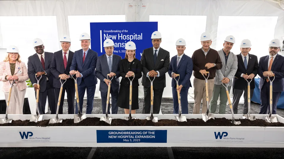 Montefiore Einstein leadership, including Philip O. Ozuah, MD, PhD, President and CEO, Montefiore Einstein, and Susan Fox, Regional Senior Vice President for the Hudson Valley, Montefiore Einstein, and President & CEO, White Plains Hospital, along with White Plains Hospital leadership, Westchester County Executive Ken Jenkins and White Plains Mayor Tom Roach, and other holding new shovels at a groundbreaking ceremony.